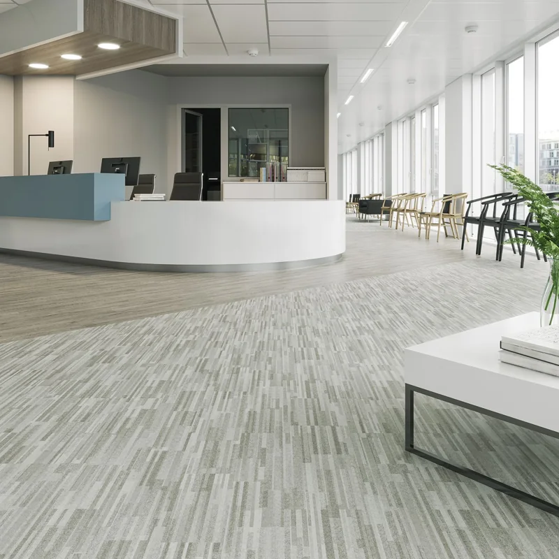 Abstract patterned vinyl flooring in a modern office reception area.