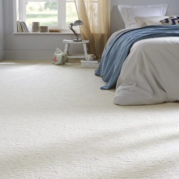 Plush cream wool carpet flooring in a modern neutral bedroom