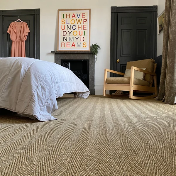 Herringbone sisal carpet in a modern bohemian bedroom