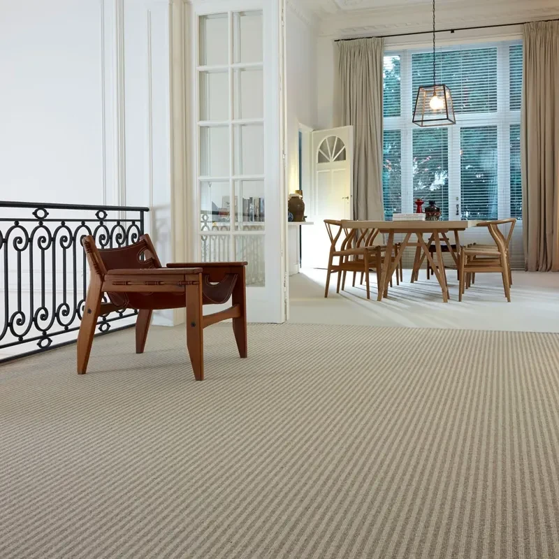 Beige striped loop carpet flooring in a spacious dining area