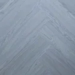 Close-up of light blue-grey herringbone wood planks