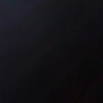 Dark charcoal wood flooring texture in dim light
