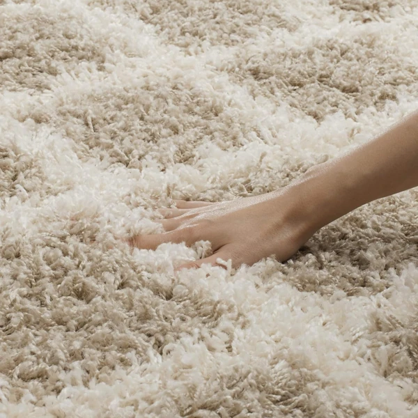 Plush cream frieze wool carpet texture close up
