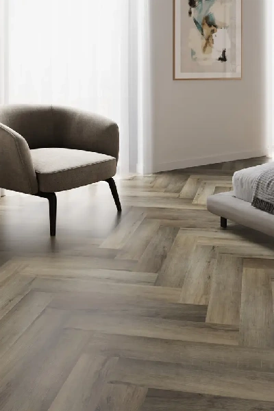 Herringbone LVT flooring in a modern bedroom.