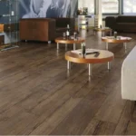 Modern office lounge with dark wood flooring.
