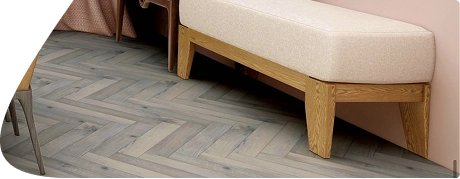 Grey herringbone wood flooring by modern bench seat.