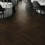 Restaurant interior with dark herringbone flooring