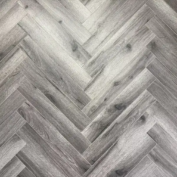 distressed dark gray laminate flooring in a herringbone pattern.