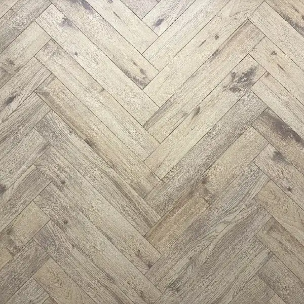 light beige wood-look laminate flooring in a herringbone pattern.