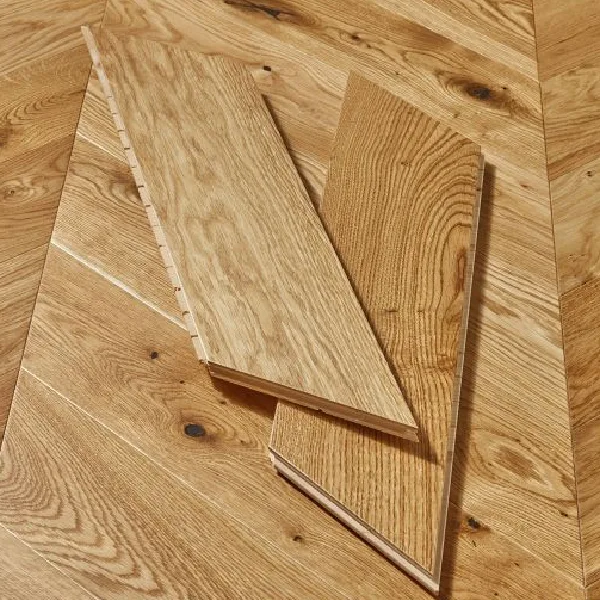 natural oak flooring planks with visible grain and knots, showing a chevron pattern