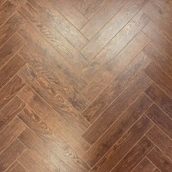 reddish-brown laminate flooring in a herringbone pattern.