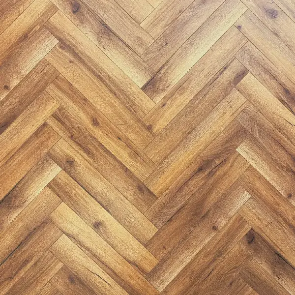 warm brown wood-look laminate flooring in a herringbone pattern.