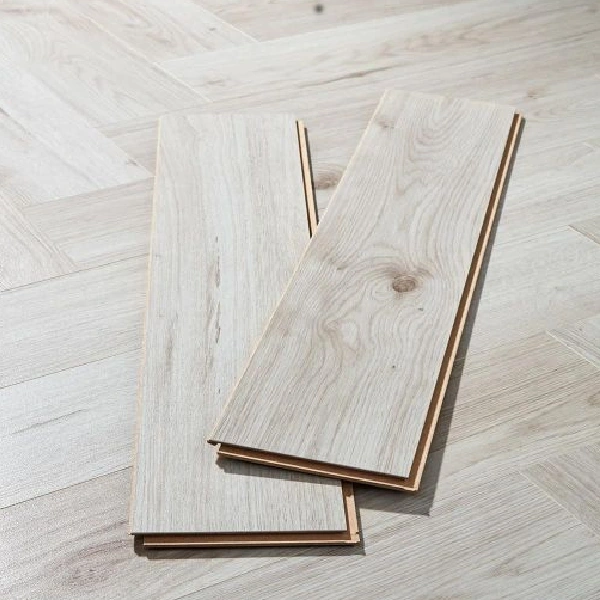 white oak-look flooring planks over a herringbone pattern.
