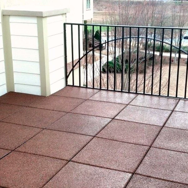 Reddish brown interlocking rubber tiles on an outdoor balcony floor