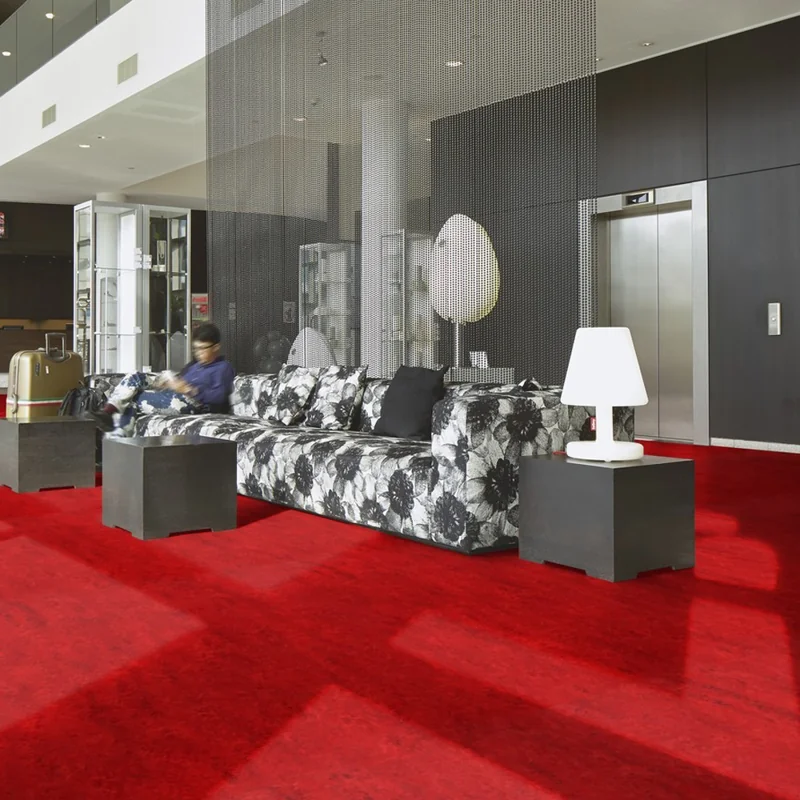 Bold red floor carpet in a brightly lit modern interior