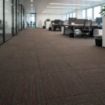 Brown patterned carpet tiles in an open office space.