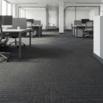 Charcoal grey patterned carpet tiles in a modern office.