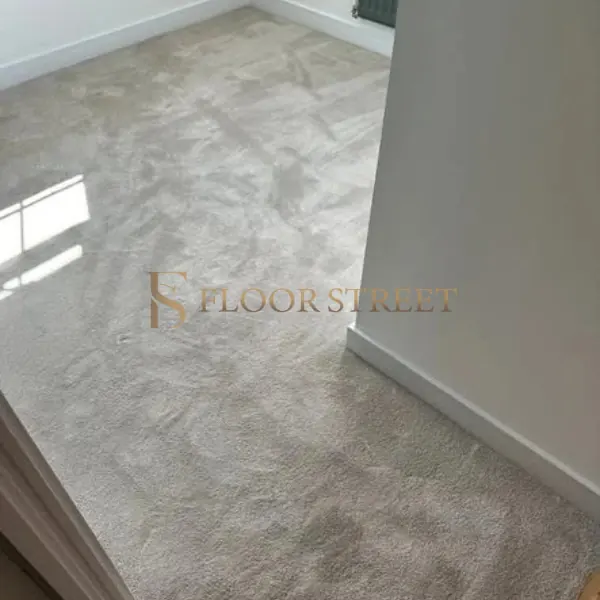 Close up of installed light brown wall-to-wall carpet