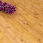 Close-up texture of horizontal natural bamboo flooring with orchids