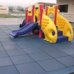 Colorful playground set on blue square rubber tiles