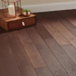 Dark brown wood flooring with a wooden cabinet