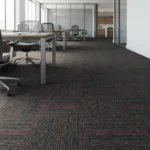 Dark grey and red striped carpet tiles in an office.