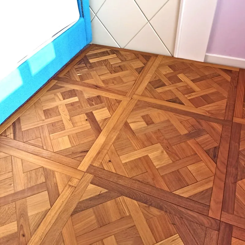 Elegant Versailles-style wood parquet flooring.