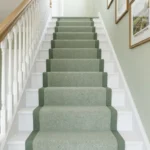 Green textured stair carpet runner on white steps