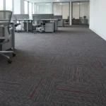 Grey and purple patterned carpet tiles in an office space.