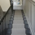 Grey ribbed stair runner on a white staircase
