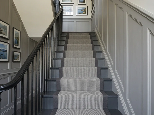Grey ribbed stair runner on a white staircase