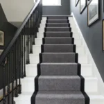 Grey stair runner with black border on white steps