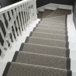 Grey striped stair carpet looking down grey steps
