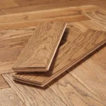 Herringbone pattern solid wood flooring planks.