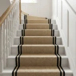 Herringbone stair carpet on white winding stairs