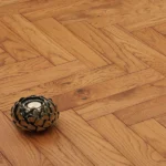 Herringbone wood floor with decorative table accessory.