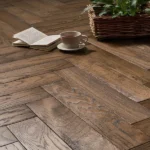 Herringbone wood flooring with a book and tea cup.