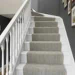 High-angle view of a grey woven stair runner.