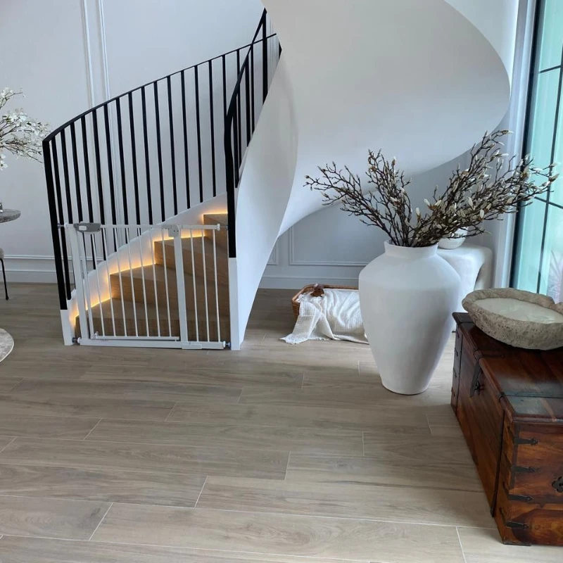 Illuminated floating wood steps matching the light-toned solid wood floor.