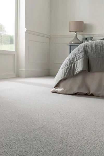 Light grey wool carpet installed in luxury bed room