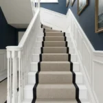 Linear loop stair runner on white wooden stairs