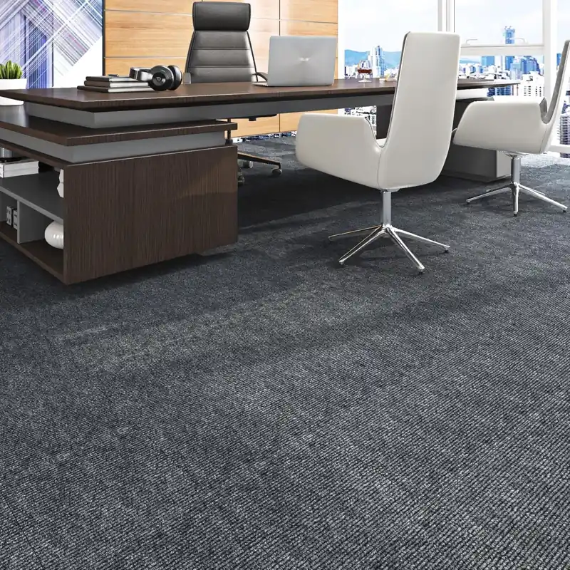 Long boardroom table on grey linear patterned carpet.