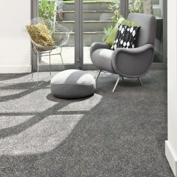 Gray loop pile carpet in a sunlit seating area