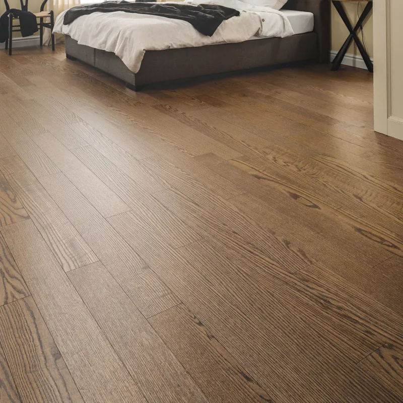 Medium-toned ash solid wood flooring in a cozy bedroom