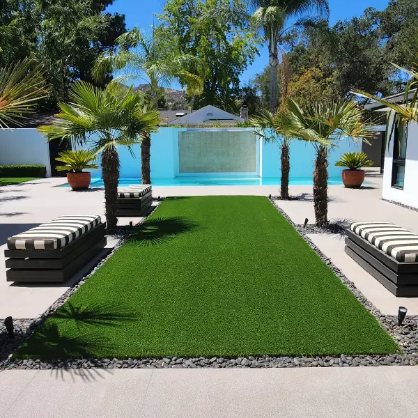 Minimalist outdoor landscape featuring an artificial grass carpet, palm trees