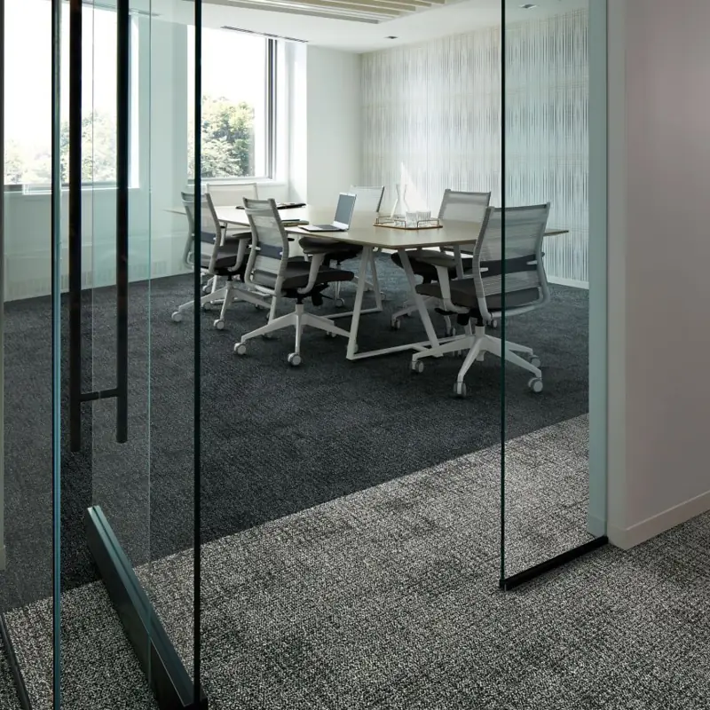 Modern office with patterned dark grey carpet tiles