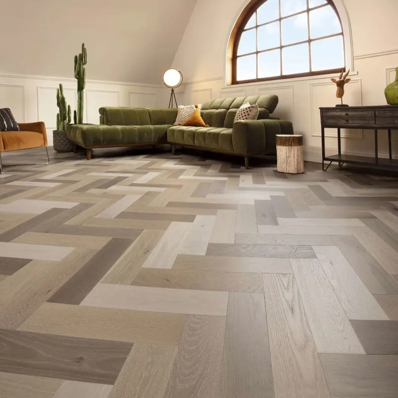 Multicolor herringbone parquet flooring in a modern living room.