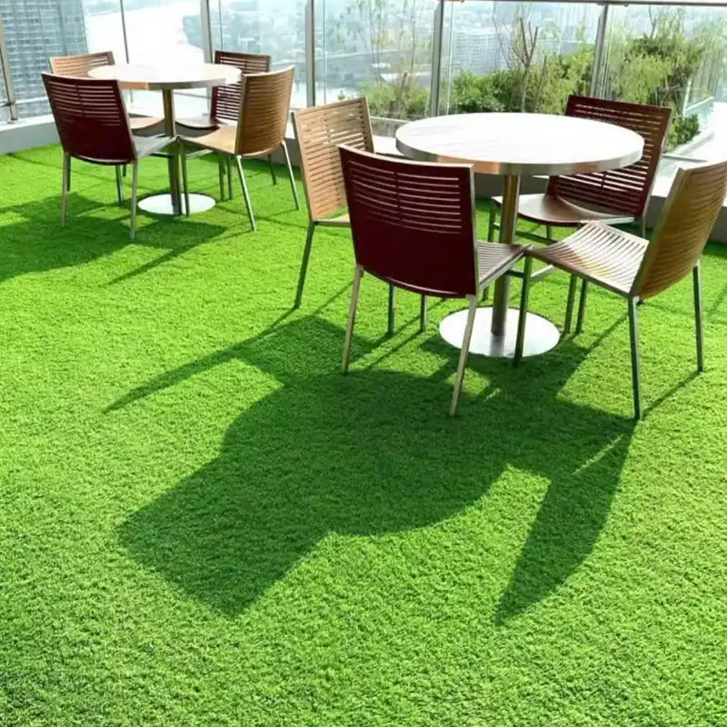 Multilevel wooden deck surrounded by lush fake grass