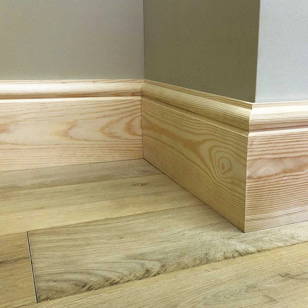 Natural light wood skirting board with a decorative profile