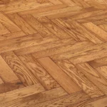 Oak wood flooring in a traditional herringbone pattern.